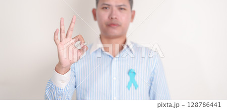 Man with blue Ribbon for concept of blue November, November Prostate Cancer Awareness month, World Diabetes day , Men Health month, International men, Father day. Healthcare and world cancer day 128786441