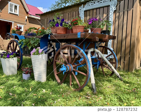 Stylish Provencal-style flower garden in a country house in summer. High quality photo Stylish Provencal-style flower garden in a country house in summer. High quality photo 128787232