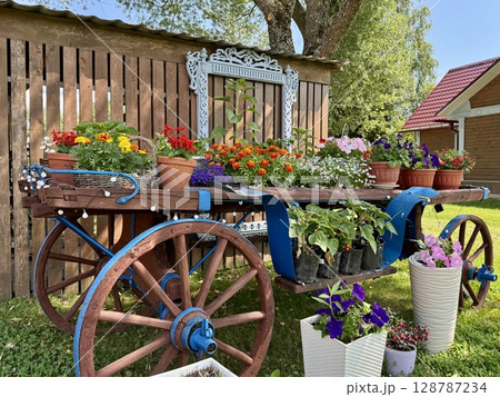 Stylish Provencal-style flower garden in a country house in summer. High quality photo Stylish Provencal-style flower garden in a country house in summer. High quality photo 128787234
