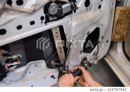Hands Engaged in the Process of Performing Automotive Interior Repairs Effectively Hands Engaged in the Process of Performing Automotive Interior Repairs Effectively 128787942