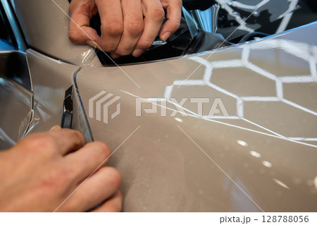 Applying a Protective Film on the Surface of Your Car for Enhanced Durability and Shine Applying a Protective Film on the Surface of Your Car for Enhanced Durability and Shine 128788056