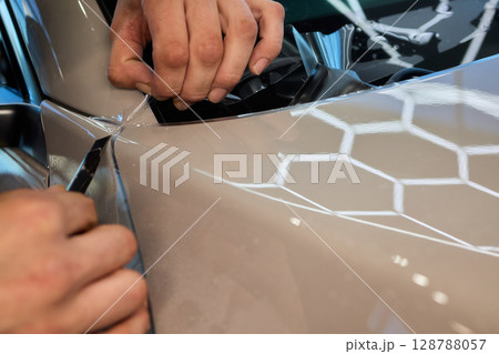 Applying a Protective Film on the Surface of Your Car for Enhanced Durability and Shine Applying a Protective Film on the Surface of Your Car for Enhanced Durability and Shine 128788057
