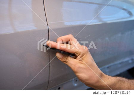 Applying a Protective Film on the Surface of Your Car for Enhanced Durability and Shine 128788114