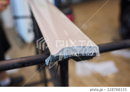 Applying a Protective Film on the Surface of Your Car for Enhanced Durability and Shine 128788133