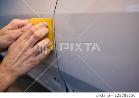 Applying a Protective Film on the Surface of Your Car for Enhanced Durability and Shine Applying a Protective Film on the Surface of Your Car for Enhanced Durability and Shine 128788150