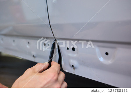 Applying a Protective Film on the Surface of Your Car for Enhanced Durability and Shine Applying a Protective Film on the Surface of Your Car for Enhanced Durability and Shine 128788151