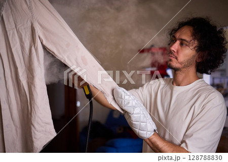 Using a Steam Iron expertly irons a shirt for a flawless, wrinkle free, polished look 128788830