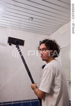 Cleaning Service Woman Cleaning The Ceiling Of The Bathroom With Mop At Home Cleaning Service Woman Cleaning The Ceiling Of The Bathroom With Mop At Home 128788849