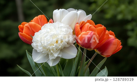 Vibrant Arrangement of Tulips and Peonies in Lush Green Background for Floral Inspiration 128789319