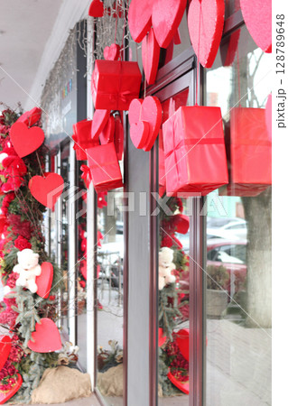 Red hearts on fir branches. Red hearts on fir branches. 128789648