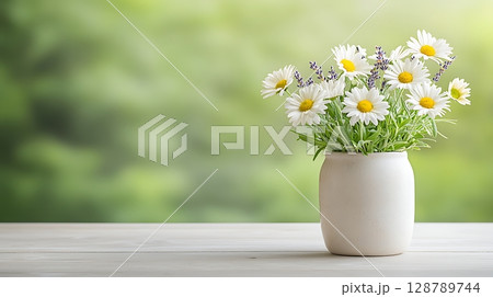 Fresh Wildflowers Arrangement in White Vase on Wooden Table with Soft Green Background 128789744