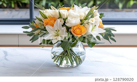 Elegant Floral Arrangement with Roses and Lilies in a Glass Vase on a Bright Surface 128790020