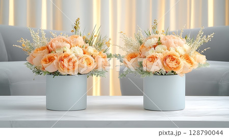 Elegant Floral Arrangements with Soft Orange Roses and Decorative Greenery on a Table 128790044