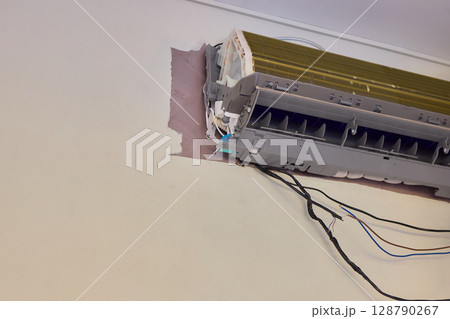 Installing a Wall Mounted Air Conditioning Unit in your home for better cooling comfort 128790267