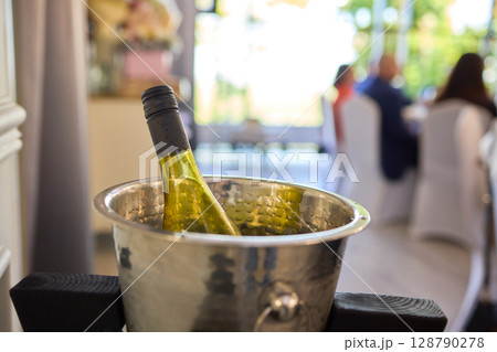 An Elegant Wine Bottle Nestled in an Ice Bucket to Enhance Your Fine Dining Experience An Elegant Wine Bottle Nestled in an Ice Bucket to Enhance Your Fine Dining Experience 128790278