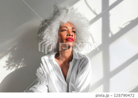 Embracing elegance and natural beauty of black middle aged woman 128790472