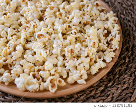 Butter salted popcorn on wooden table. Butter salted popcorn on wooden table. 128791192