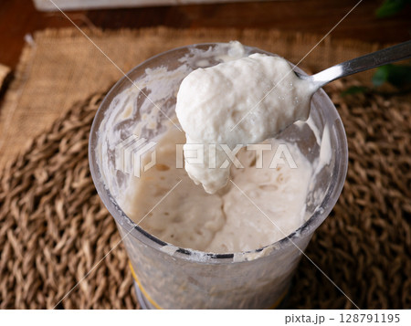 Bubbly sourdough starter in glass jar. Active yeast for bread making Bubbly sourdough starter in glass jar. Active yeast for bread making 128791195