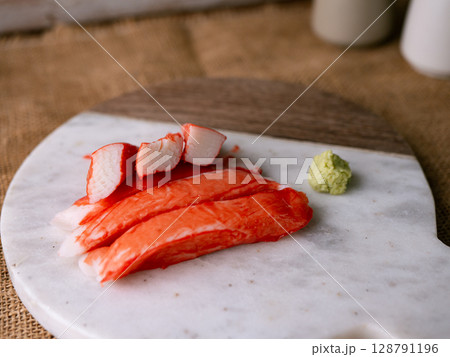 Fresh crab sticks surimi set on white plate with wasibi. Fresh crab sticks surimi set on white plate with wasibi. 128791196