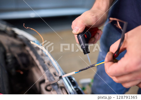 wrap lightning port with heat shrink tube and lighter on white background 128791365