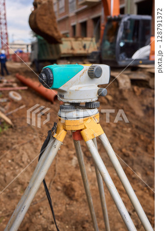 High Precision Surveying Equipment Utilized on a Construction Site for Enhanced Accuracy and Control 128791372