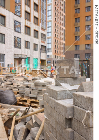 There are numerous piles of concrete debris observable at the busy construction site right now 128791374