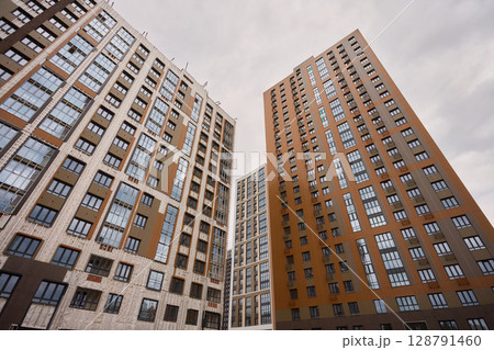 A bustling Construction Site showcasing Cranes, Building Framework, and full activity all around A bustling Construction Site showcasing Cranes, Building Framework, and full activity all around 128791460