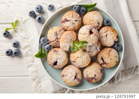 Gluten free blueberry cookies served with fresh blueberries closeup in the bowl. Horizontal top view Gluten free blueberry cookies served with fresh blueberries closeup in the bowl. Horizontal top view 128791997