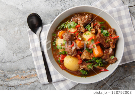 Semur Daging or Sweet Beef Stew closeup in the bowl. Horizontal top view Semur Daging or Sweet Beef Stew closeup in the bowl. Horizontal top view 128792008