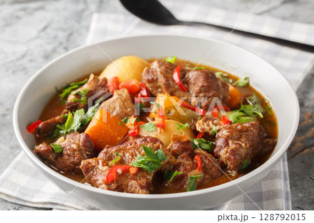 Semur Daging Indonesian braised beef with spices and sweet soy sauce closeup in the bowl. Horizontal 128792015