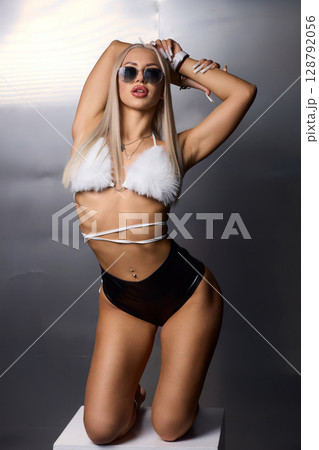 A Stylish Fitness Model is Posing Beautifully in a Chic Bikini for an Exciting Photoshoot 128792056