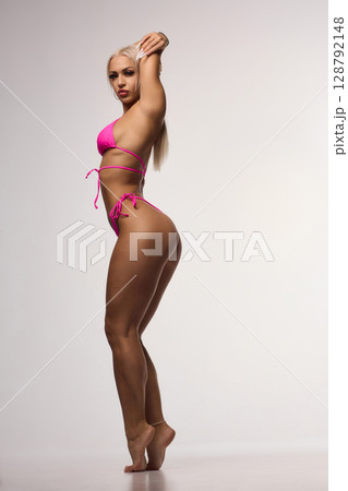 A Stylish Fitness Model is Posing Beautifully in a Chic Bikini for an Exciting Photoshoot A Stylish Fitness Model is Posing Beautifully in a Chic Bikini for an Exciting Photoshoot 128792148