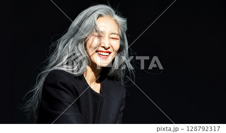 Embracing the beauty of silver hair and joy, this stunning portrait radiates elegance and happiness 128792317