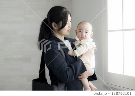 赤ちゃんを抱くワーキングマザー 赤ちゃんを抱くワーキングマザー 128793101