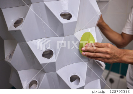 Engaging in a Cleaning Activity within a Contemporary Bathroom Environment Setting Engaging in a Cleaning Activity within a Contemporary Bathroom Environment Setting 128795558