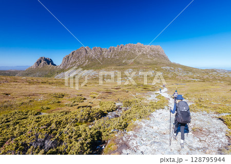 Hikers at Cradle Mountain in Tasmania Australia Hikers at Cradle Mountain in Tasmania Australia 128795944