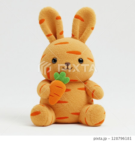 Cute orange rabbit plush toy holding a carrot, a soft stuffed bunny isolated on white background 128796181