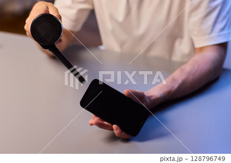 The Innovative Smartphone Cleaning Device is Being Demonstrated During Use and Functionality 128796749
