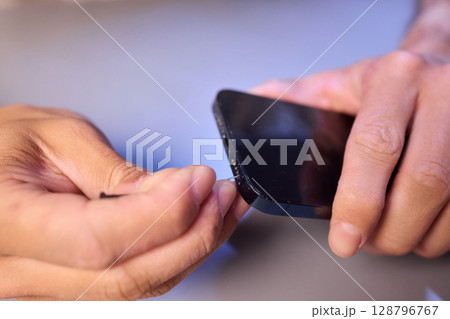 The Innovative Smartphone Cleaning Device is Being Demonstrated During Use and Functionality 128796767