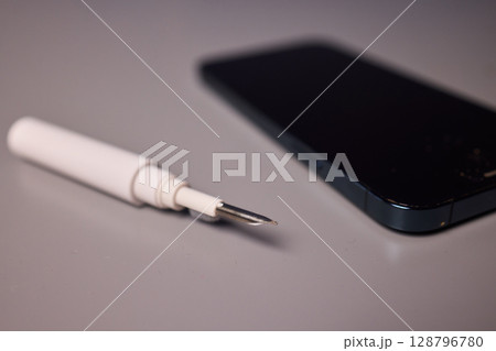 The Innovative Smartphone Cleaning Device is Being Demonstrated During Use and Functionality 128796780