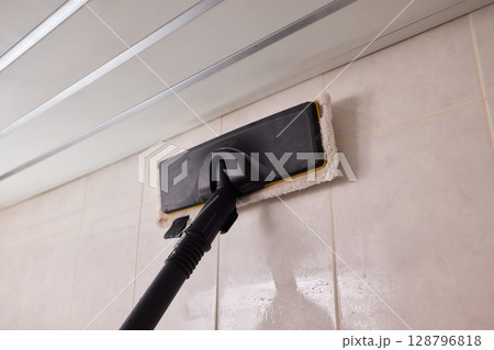 Efficient Bathroom Tile Cleaning with the Innovative Vacuum Mop for Modern Homes 128796818