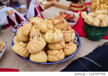 Savor the Delicious Golden Dumplings uchpochmak Beautifully Served on a Colorful and Inviting Table Savor the Delicious Golden Dumplings uchpochmak Beautifully Served on a Colorful and Inviting Table 128797709