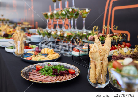An Elegant Assortment of Gourmet Desserts and Savory Snacks Beautifully Arranged on Table 128797763