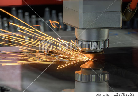 Close up scene the fiber laser cutting machine cut the metal plate control by CNC program. Close up scene the fiber laser cutting machine cut the metal plate control by CNC program. 128798355