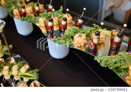 An Elegant Assortment of Gourmet Desserts and Savory Snacks Beautifully Arranged on Table An Elegant Assortment of Gourmet Desserts and Savory Snacks Beautifully Arranged on Table 128798661