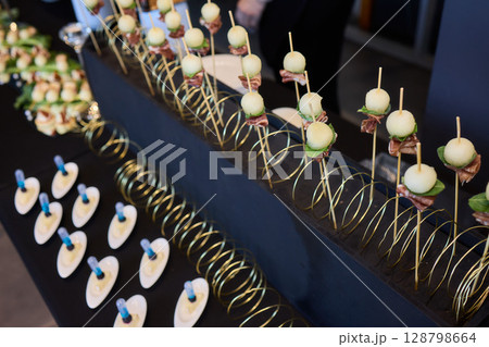 An Elegant Assortment of Gourmet Desserts and Savory Snacks Beautifully Arranged on Table An Elegant Assortment of Gourmet Desserts and Savory Snacks Beautifully Arranged on Table 128798664