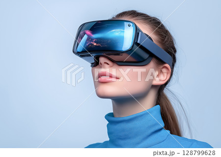 A close-up of a face wearing VR glasses, with vibrant reflections of the virtual world visible, on plain background 128799628
