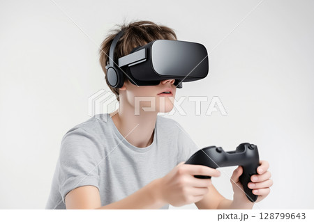 A gamer in motion, wearing VR glasses and holding controllers during an intense gameplay session 128799643