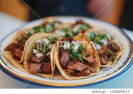 A plate of traditional Mexican street tacos with carne asada, onions, and cilantro A plate of traditional Mexican street tacos with carne asada, onions, and cilantro 128800017