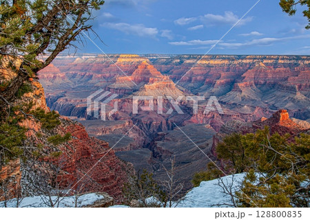 Wide Grand Canyon panorama with snowy rim 128800835